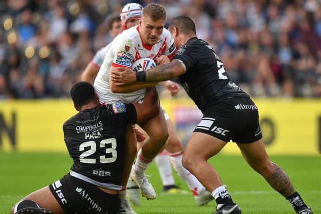 St Helens' Matty Lees is tackled by Hull FC's Mickey Paea (left) and Sika Manu during the Betfred Super League match at the KCOM Stadium, Hull. (Photo: Dave Howarth/PA Wire)