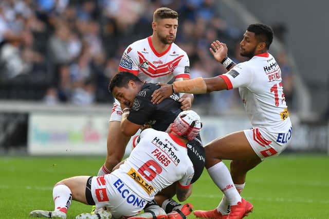 Hull FC's Bureta Faraimo is brought down by a swarm of St Helens defenders. (PHOTO: Dave Howarth/PA Wire)