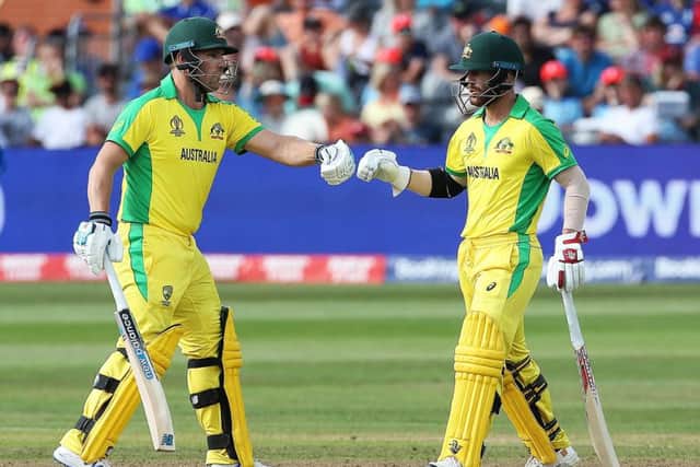 Australia's David Warner (right) and Captain Aaron Finch fist pump as they reach fifty during the ICC Cricket World Cup group stage match at Bristol County Ground. (Picture: PA)