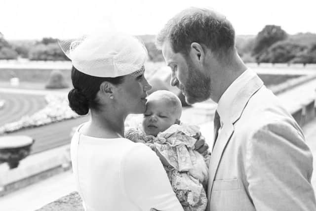 This official christening photograph released by the Duke and Duchess of Sussex shows the Duke and Duchess with their son, Archie Harrison Mountbatten-Windsor at Windsor Castle with with the Rose Garden in the background. Picture by Chris Allerton/SussexRoyal.
