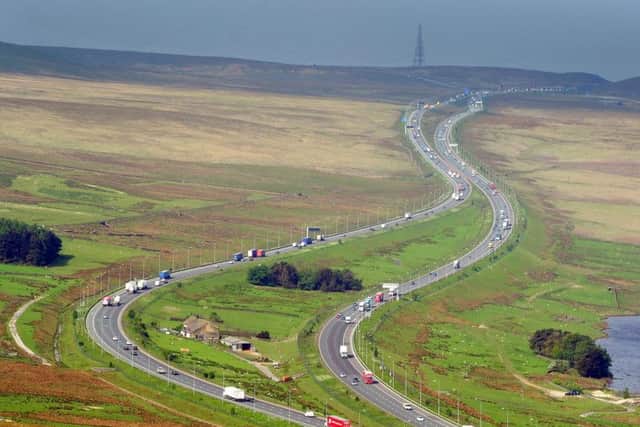 The M62 in West Yorkshire as it splits past Stott Hall Farm, home of the Thorp family, and snakes up Moss Moor over the Pennines. Picture by Tony Johnson.