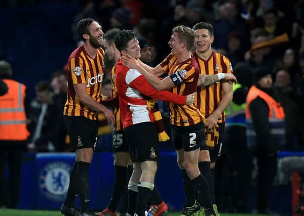 Bradford City's Stephen Darby (second right) celebrates with team-mate Billy Knott (second left) and Rory McArdle (left) at Stamford Bridge in January 2015. Picture: John Walton/PA