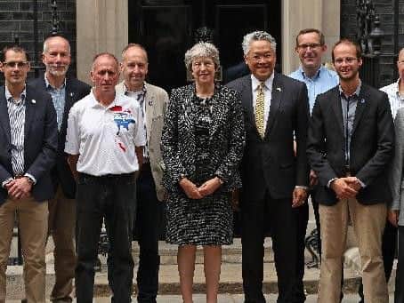 Prime Minister Theresa May with the Thai Ambassador Pisanu Suvanajata (centre right) at Downing Street, London with the divers and support team from the British Cave Rescue Council following the rescue last year