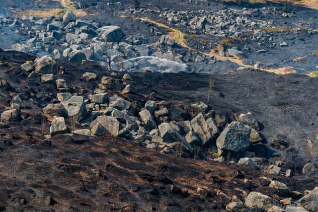 Firefighters continue to damp down after a fire broke out on Ilkley Moor over Easter.