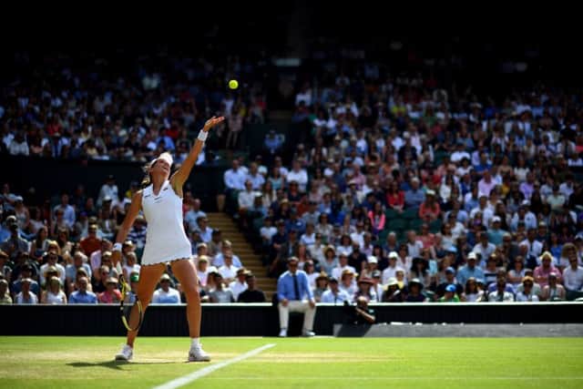 Johanna Konta serves on Centre Court during her defeat to Barbara Strycova. Picture: Victoria Jones/PA