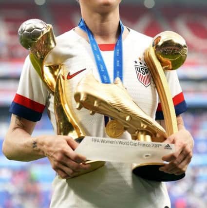 USA's Megan Rapinoe celebrates with her adidas Golden Boot award, adidas Golden Ball award, and Fifa Women's World Cup Trophy after the final whistle after the FIFA Women's World Cup 2019 Final at the Stade de Lyon, Lyon, France. PRESS ASSOCIATION Photo. Picture date: Sunday July 7, 2019. See PA story SOCCER Final. Photo credit should read: PA Wire. RESTRICTIONS: Editorial use only. No commercial use. No use with any unofficial 3rd party logos. No manipulation of images. No video emulation.