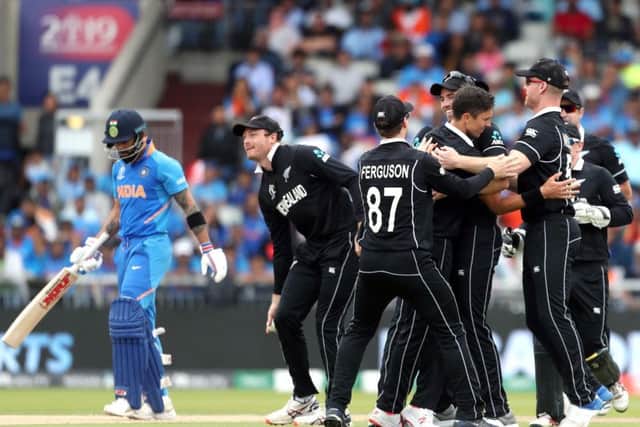New Zealand's Trent Boult celebrates with team-mates after taking the wicket of India's Virat Kohli at Old Trafford. Picture: David Davies/PA