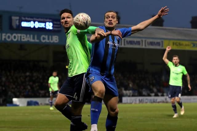 Cardiff City's Sean Morrison (left) and Gillingham's Tom Eaves battle for the ball.