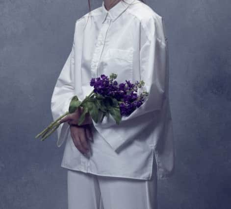 White shirt, £35.99, and white trousers, £49.99, from Mango, styled with purple stock flowers. Picture by Stevieroy at Brussels Street Studio in Leeds, see stevieroy.co.uk