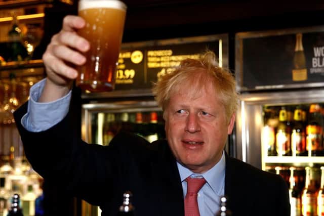 Boris Johnson raises a glass after pulling a pint at an event on the Tory leadership campaign trail.