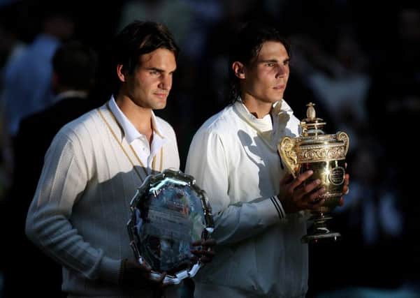 Spain's Rafael Nadal and Switzerland's Roger Federer with their trophies back in 2008.
