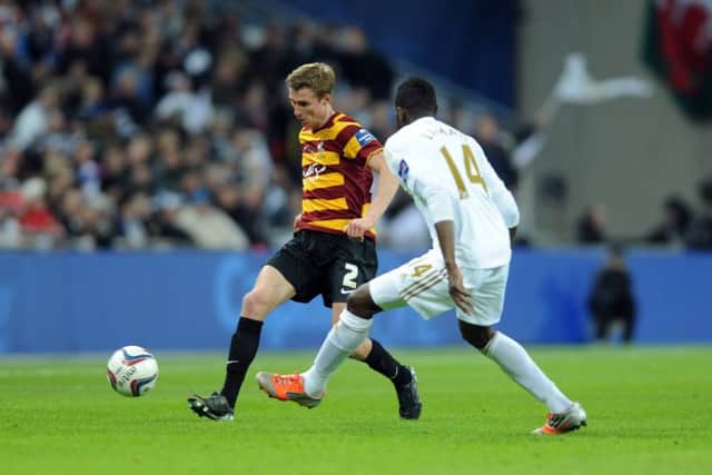 Stephen Darby knocks the ball past Swansea's Roland Lamah during the 2013 League Cup final. (Picture: Tony Johnson)