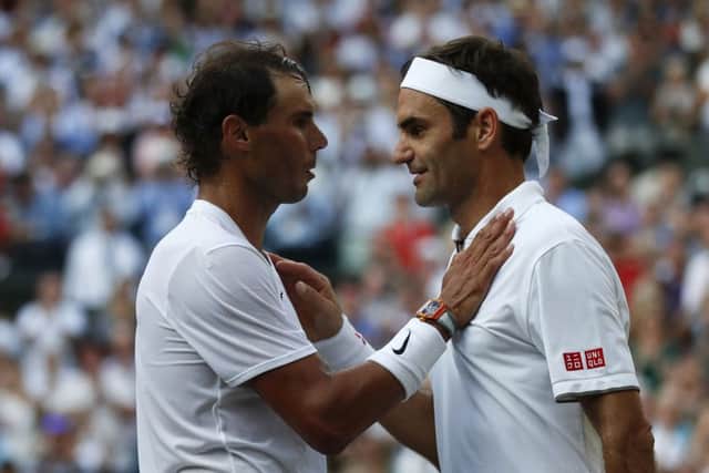 Roger Federer consoles Rafael Nadal. Picture: Adrian Dennis/PA