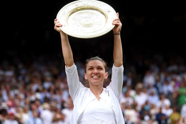 Simona Halep celebrates with the trophy on Centre Court. Picture: Toby Melville/PA