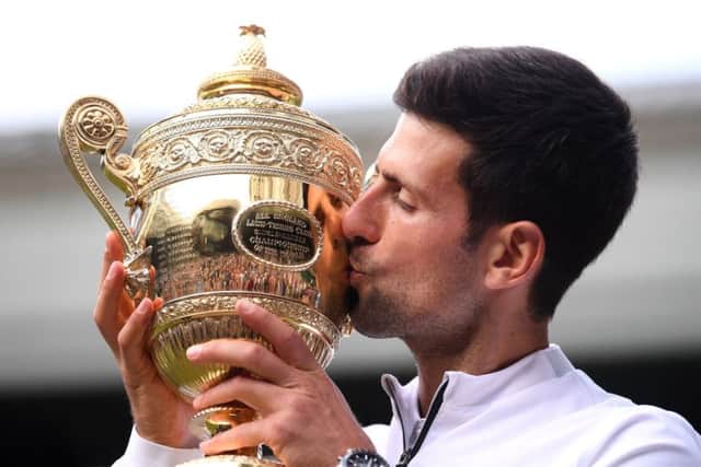 CHAMPION MOMENT: Novak Djokovic kisses the Wimbledon trophy - which he was presented with by the Duchess of Cambridge. Picture: Will Oliver/PA