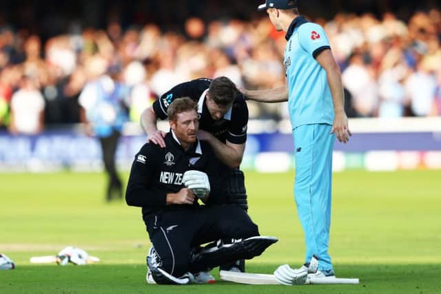 NOT TO BE: Martin Guptill is consoled by New Zealand team-mate Jimmy Neesham and England's Chris Woakes after the dramatic Super Over conclusion of the World Cup Final at Lord's. Picture: Michael Steele/Getty Images