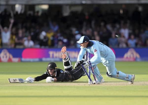THAT WINNING MOMENT: England's Jos Buttler runs out New Zealand's Martin Guptill to clinch a dramatic victory at Lord's and clinch the country;s first-ever World Cup. Picture: AP/Aijaz Rahi