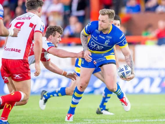 Warrington's Blake Austin offloads as he's tackled by Hull KR's George Lawler. (PIC: Allan McKenzie/SWpix.com)