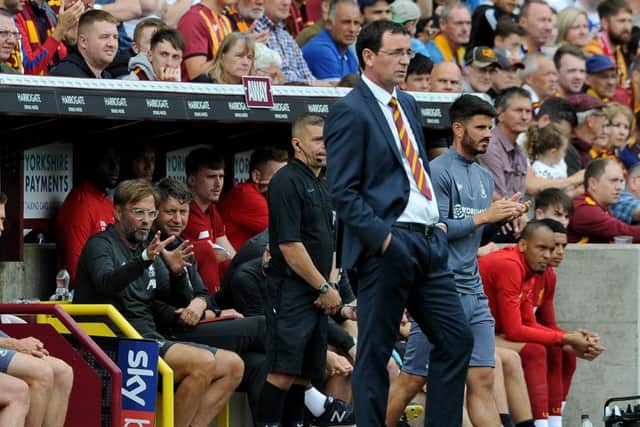 Jurgen Klopp is pictured on the touchline with Gary Bowyer at Valley Parade (Picture: Simon Hulme)