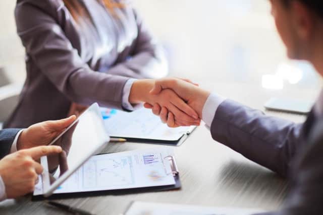 Business people shaking hands, finishing up a meeting. Picture: Adobe Stock