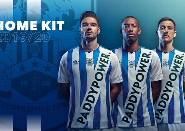 Sash of the day: Huddersfields players sport the clubs controversial new kit. (Picture: Huddersfield Town)