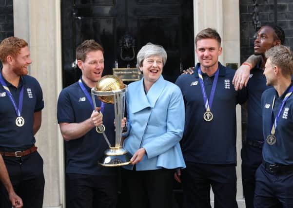 Theresa May on the steps of 10 Downing Street with the cricket World Cup.