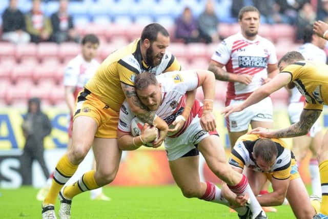 Craig Huby (left), in action for Castleford Tigers against Wigan back in 2014. Picture: Martin Rickett/PA