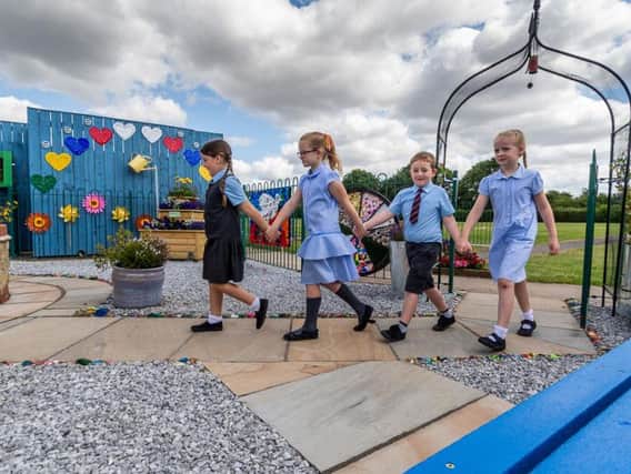 Stanley Metcalf's twin sister Elsie leads her brother's friend through a special peace garden that has opened in his memory at St Mary's Queen of Martyr's School in Bransholme, Hull.