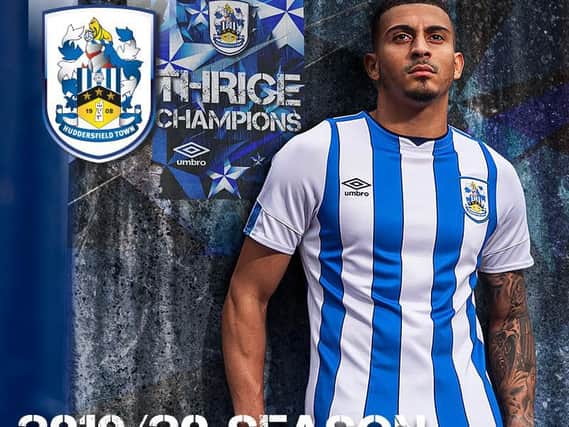 Karlan Grant models the new, sponsor-free, shirt that Huddersfield Town will wear this season