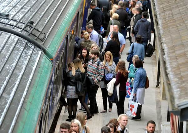 Commuters trying to board a trian at Horsforth during last year's rail chaos.
