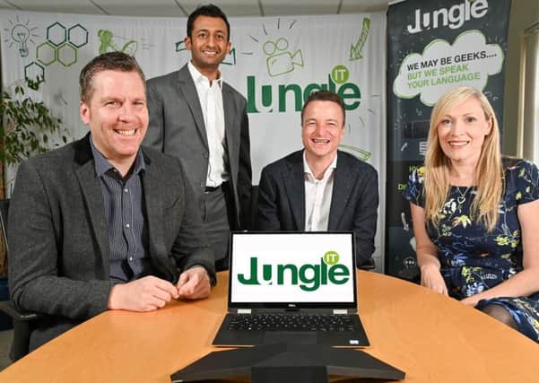 Done deal: David Blythe, chief technology officer of Jungle IT; Hitesh Tailor of Clarion; Jonathan Asquith, managing director of Jungle IT, and the companys financial director Jackie Wilkinson
