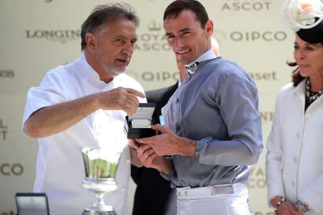 Raymond Blanc (left) presents a trophy to jockey Danny Tudhope after Space Traveller won the Jersey Stakes during day five of Royal Ascot