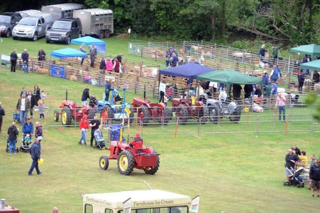 A display of vintage tractors alongside livestock pens at the 137th Bingley Show. Picture by Tony Johnson.