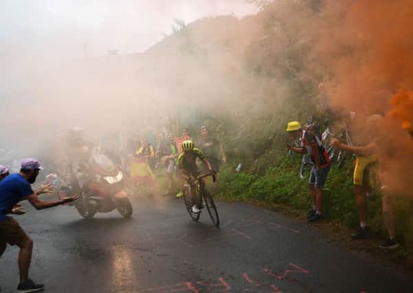 Great Britain's Simon Yates leads the race as as smoke from fans billows during the 15th stage of the Tour de France. Picture: Anne-Christine Poujoulat/Getty Images)