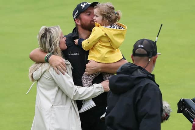 Shane Lowry celebrates winning the The Open at Royal Portrush with wife Wendy Honner and their daughter. Picture: Niall Carson/PA