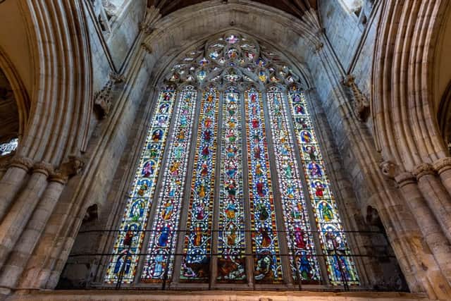 Date: 2nd July 2019. Picture James Hardisty. YP Magazine. Feature at Selby Abbey, which is celebrating it's 950th Anniversary. Pictured The East Window, dating from c1330, is the jewel of the abbey. It is often called the Jesse window as its theme shows the family three of the kings of Israel leading to Mary and the Christ child. The Day of Judgement with St.Michael weighing souls is portrayed in the upper section. The section on the left represents heaven and the section on the right represents hell.