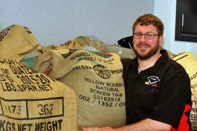 Mark Armstrong with sacks of coffee at Shiloh Coffee Roasters in Leeds.
