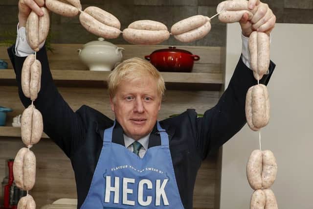 Boris Johnson holding up a string of sausages around his neck during a visit to Heck Foods Ltd, headquarters near Bedale in North Yorkshire, earlier this month. (PA).