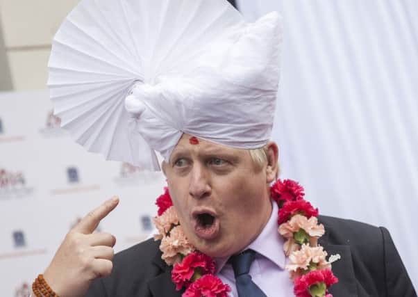 Boris Johnson in 2014 as Mayor of London, wearing a traditional headdress during a visit to the Shree Swaminarayan Mandir, a major new Hindu temple being built in Kingsbury. (Getty Images).