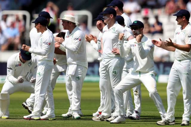 Got him: Ireland celebrate after Joe Root is trapped lbw by Mark Adair.
