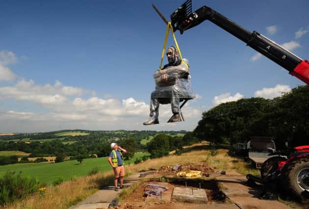 The Seated Figure by artist Sean Henry is lifted into place at the Yorkshire Sculpture Park. Picture by Simon Hulme