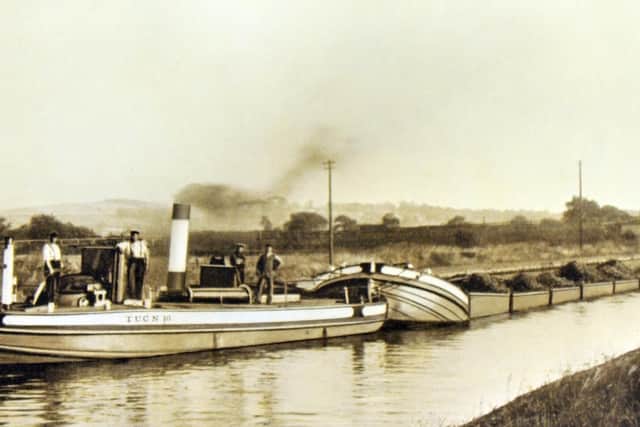 A steam tug pulling Tom Puddings laden with coal on the Aire and Calder Navigation.