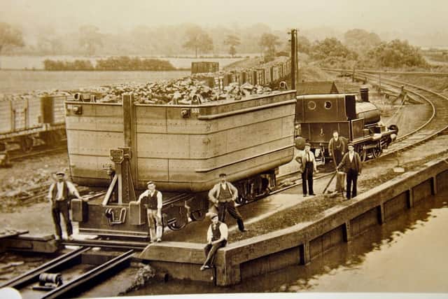 A loaded Tom Pudding being lowered into the water at Stanley Ferr before forming a train of boats to be towed to Goole on the Aire and Calder Navigation.