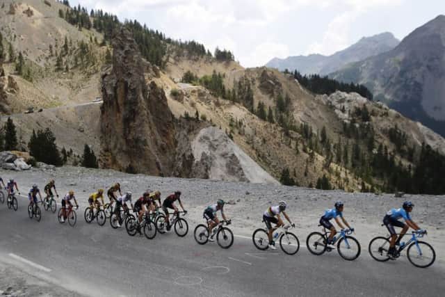 France's Julian Alaphilippe wearing the overall leader's yellow jersey rides with the pack rides during the eighteenth stage of the Tour de France in Valloire Picture: AP/ Christophe Ena