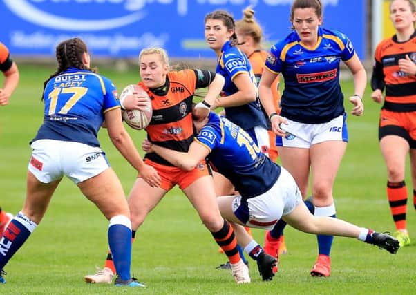 Final showdown: Castleford's Sinead Peach being tackled by Leeds duo Shannon Lacey and Sophie Nuttall in an earlier encounter.
