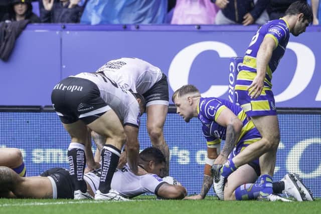 Try: Hull FC's Bureta Faraimo is congratulated by team-mates on scoring a try against Warrington.
