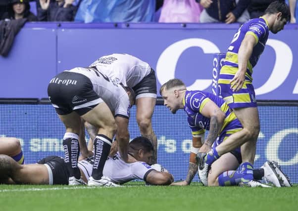 Try: Hull FC's Bureta Faraimo is congratulated by team-mates on scoring a try against Warrington.