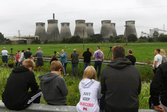 People gather to get a good viewing spot before the first of the Ferrybridge cooling towers is demolished.