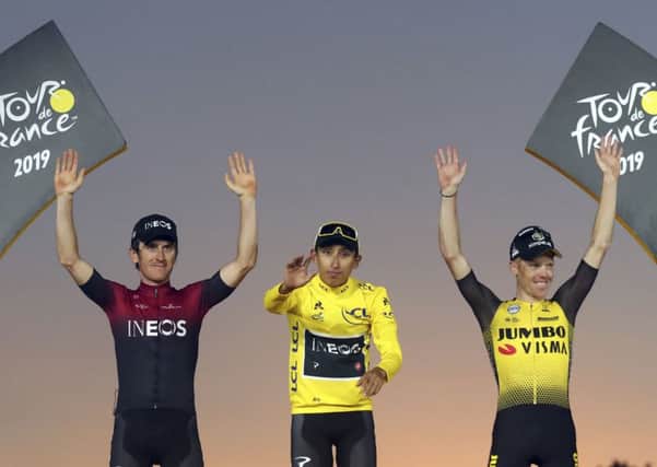 Colombia's Egan Bernal, middle, Britain's Geraint Thomas, who placed second, left, and the Netherlands' Steven Kruijswijk, third, celebrate on the podium of the Tour de France. Picture: AP/Thibault Camus