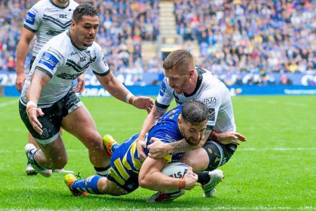 Hull FC's Marc Sneyd can't prevent Warrington's Toby King from scoring a try. Picture: Allan McKenzie/SWpix.com